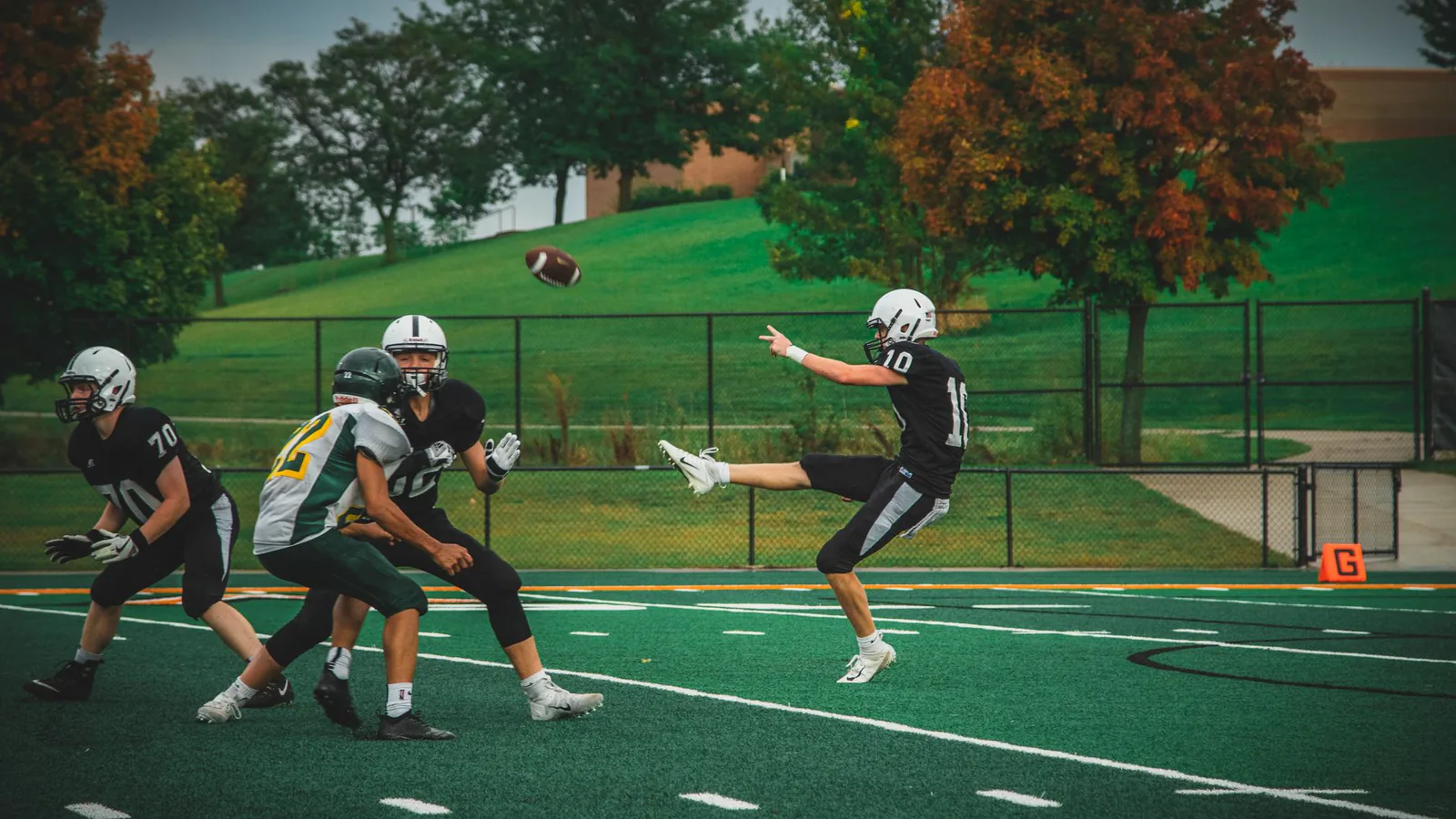 Players in action during an American football game on a green field