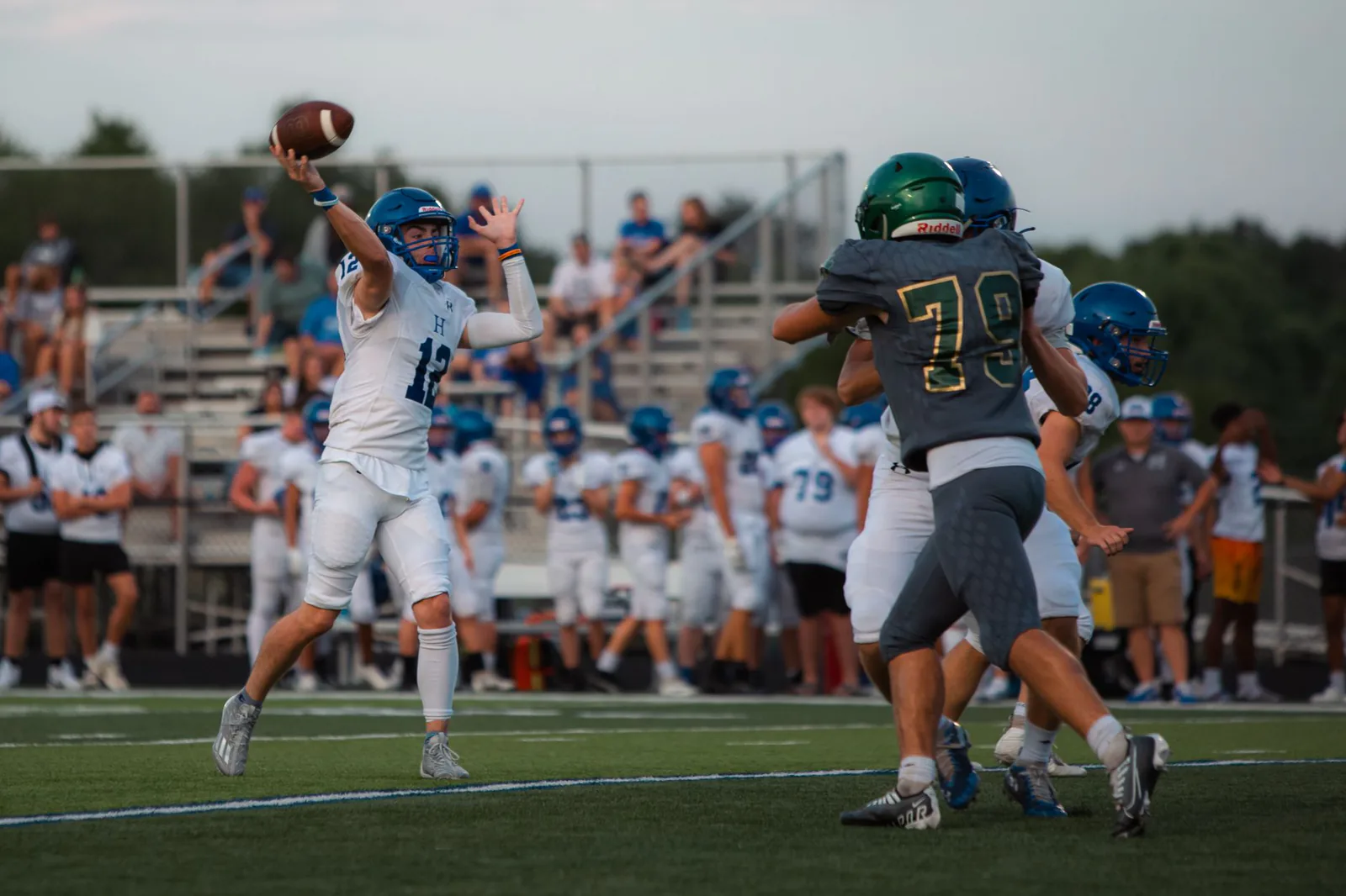 High school quarterback throwing a pass under pressure