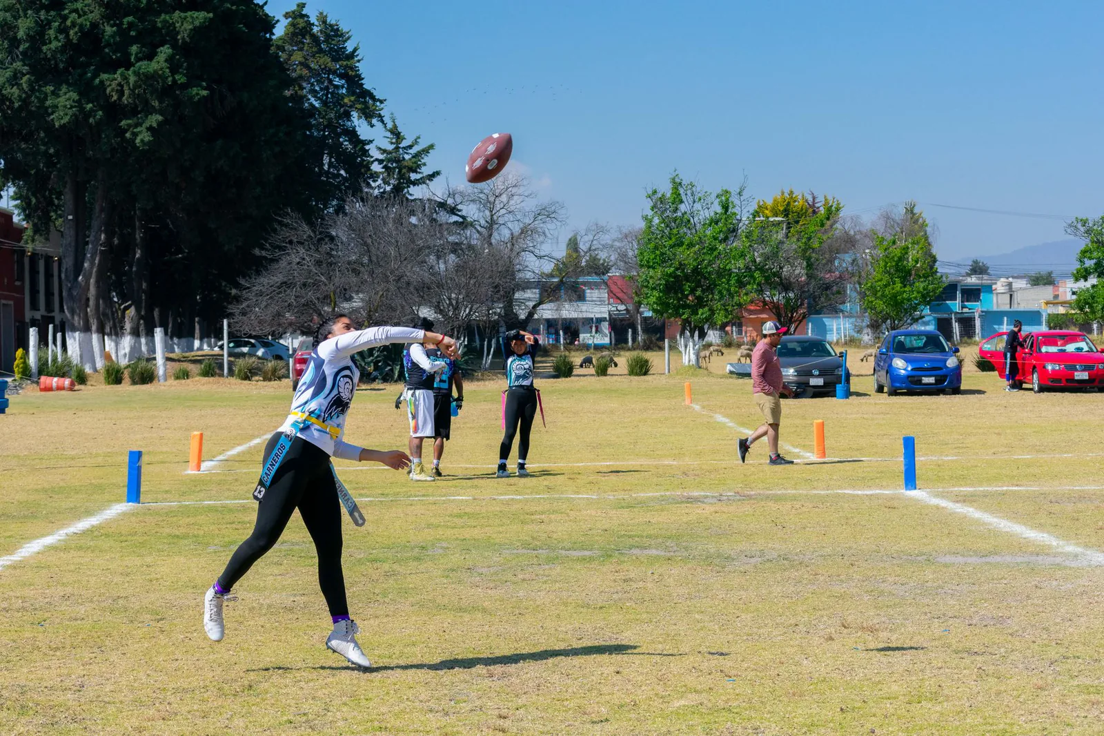 Young athlete running with the football during a training session