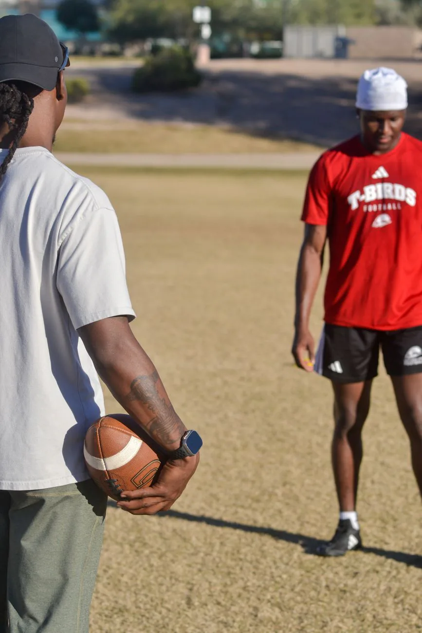 Two athletes working through football drills together
